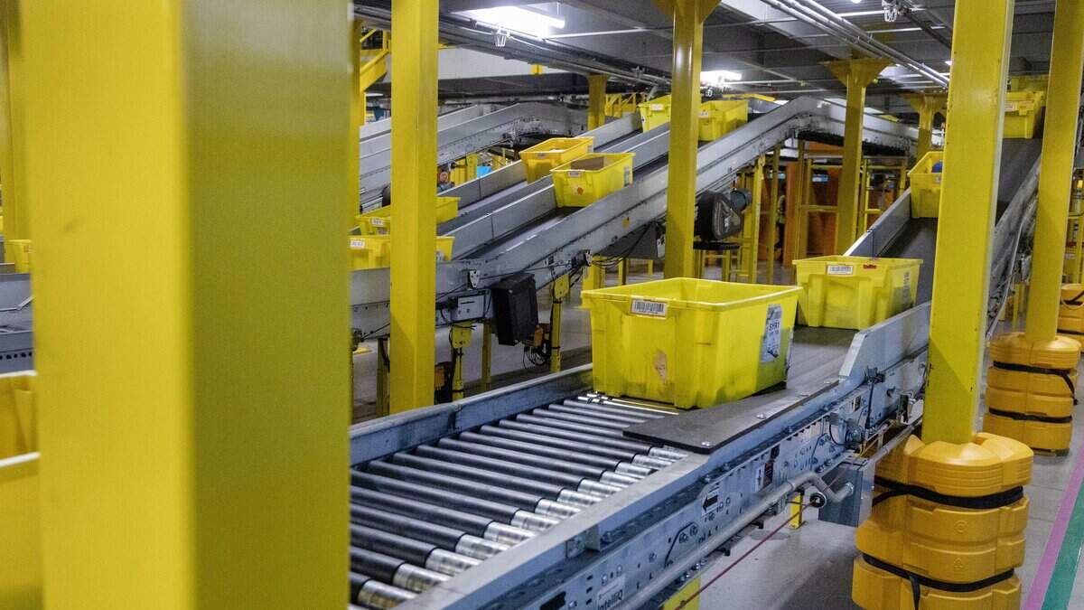 Amazon bins move inventory along a conveyor belt at the Nampa Fulfillment Center, Thursday, June 25, 2026.