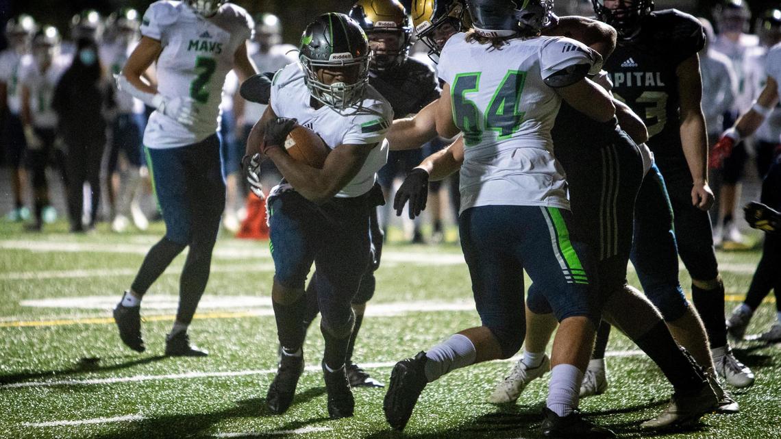 Mountain View’s Quintez Evans finds a gap to tie the game at 14 in the second quarter.