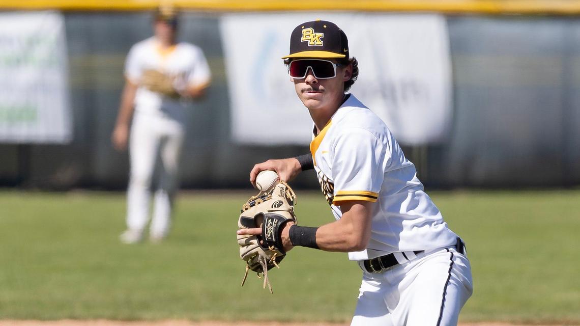 Bishop Kelly’s Dean Herkenrath makes a throw from third base during a 4A state tournament game against Twin Falls at Vallivue High School on Thursday.