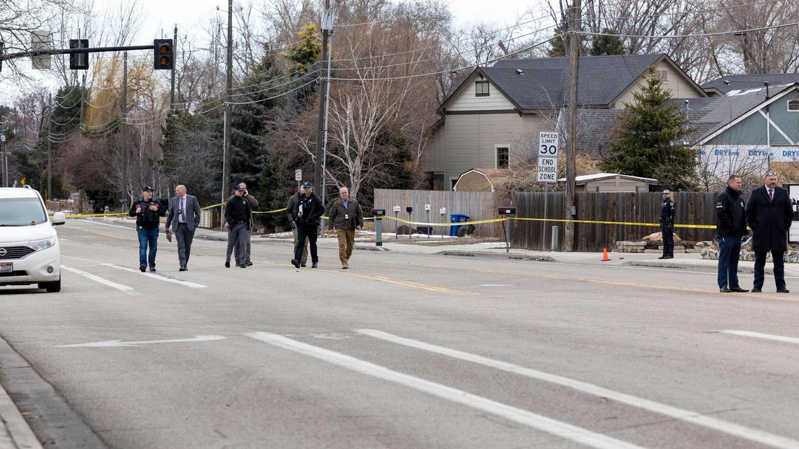 Investigators survey the scene where a police pursuit ended and a suspect was shot in an area along E. Boise Avenue east of the Apple Street intersection Wednesday.