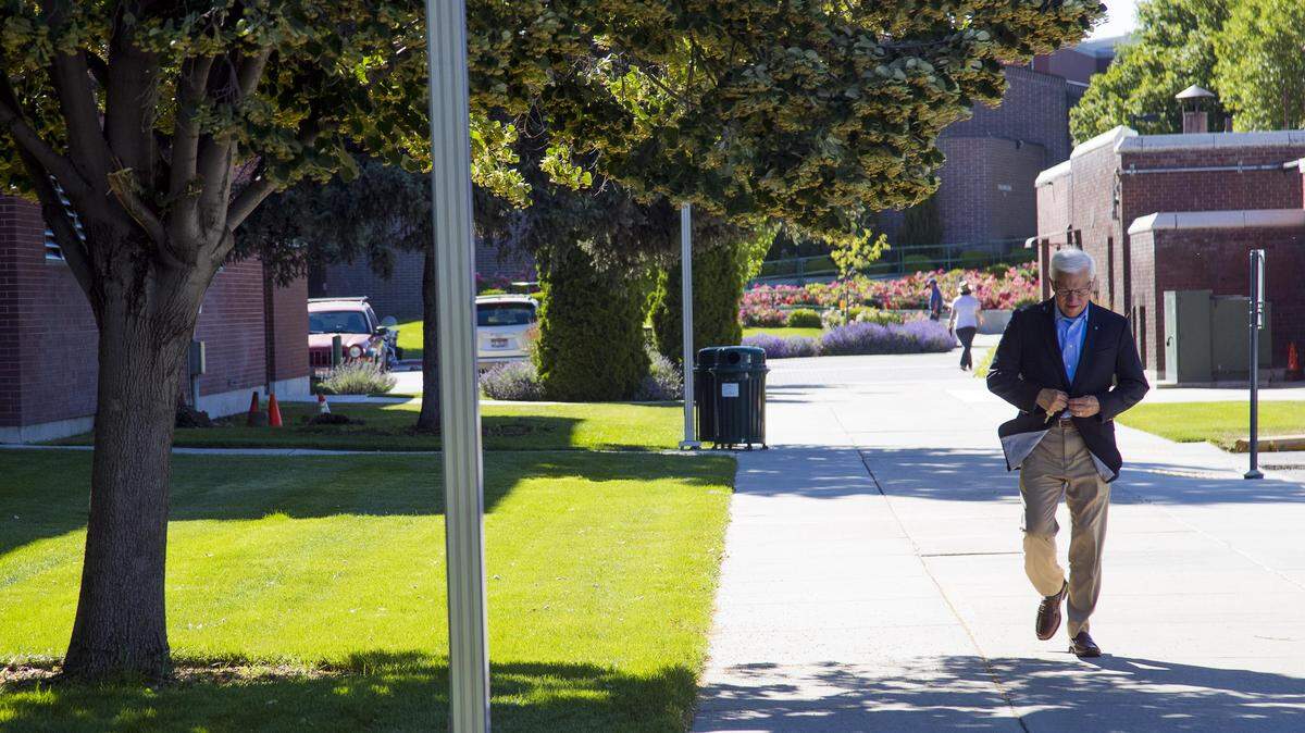 Bob Kustra walks to his office along Boise State's campus Friday.