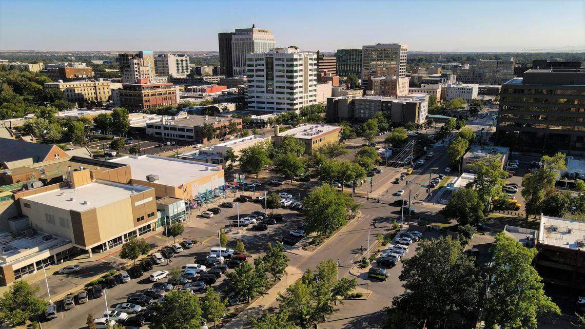 Developers are planning to redevelop multiple blocks of land in downtown Boise just south of Boise High School, which is just outside of this south-looking photo below the lower left corner. The project would move the YMCA, center left, a block south across State Street, and it would construct two buildings, one 15-story and the other seven-story, for hundreds of apartments and ground-floor businesses.