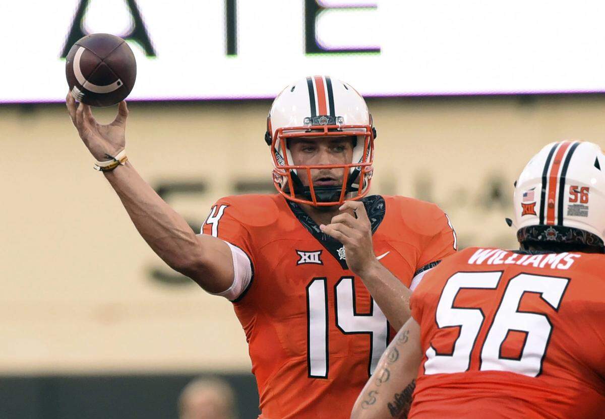 In this Aug. 30, 2018, file photo, Oklahoma state quarterback Taylor Cornelius (14) throws a pass during the first quarter of an NCAA college football game against Missouri State, in Stillwater, Okla.