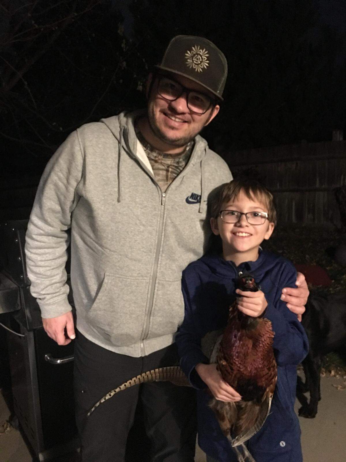 Dan Barker and son Linkon pose with the pheasant they harvested earlier this month.