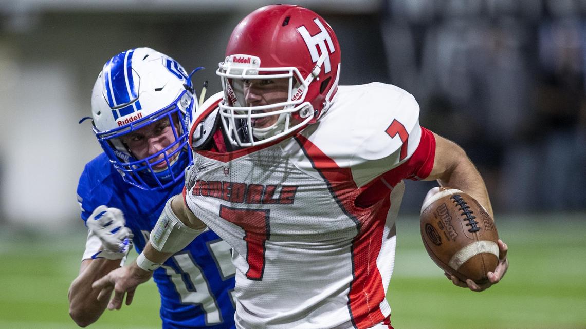 Homedale quarterback Daniel Uranga tries to escape pressure from Sugar-Salem’s Brayton Pope in the 3A state football championship Saturday at Holt Arena in Pocatello.