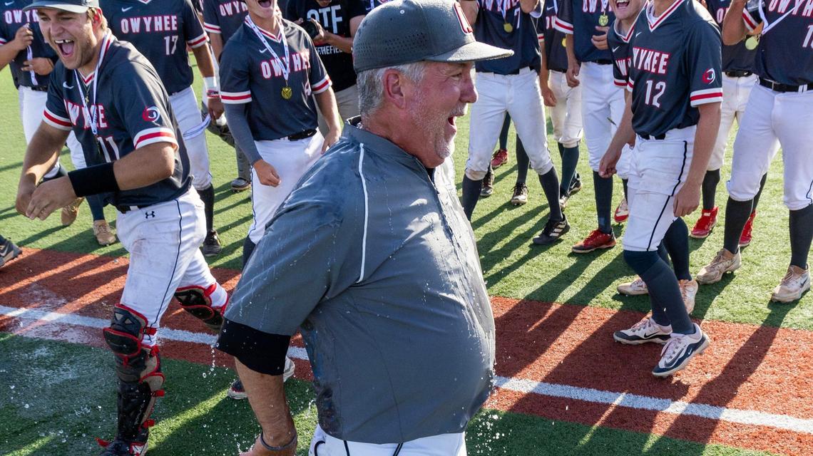 Owyhee coach Russ Wright fills the chill after getting doused with ice water by his players following a 5-4 win over Rocky Mountain in the 5A state championship game Saturday.
