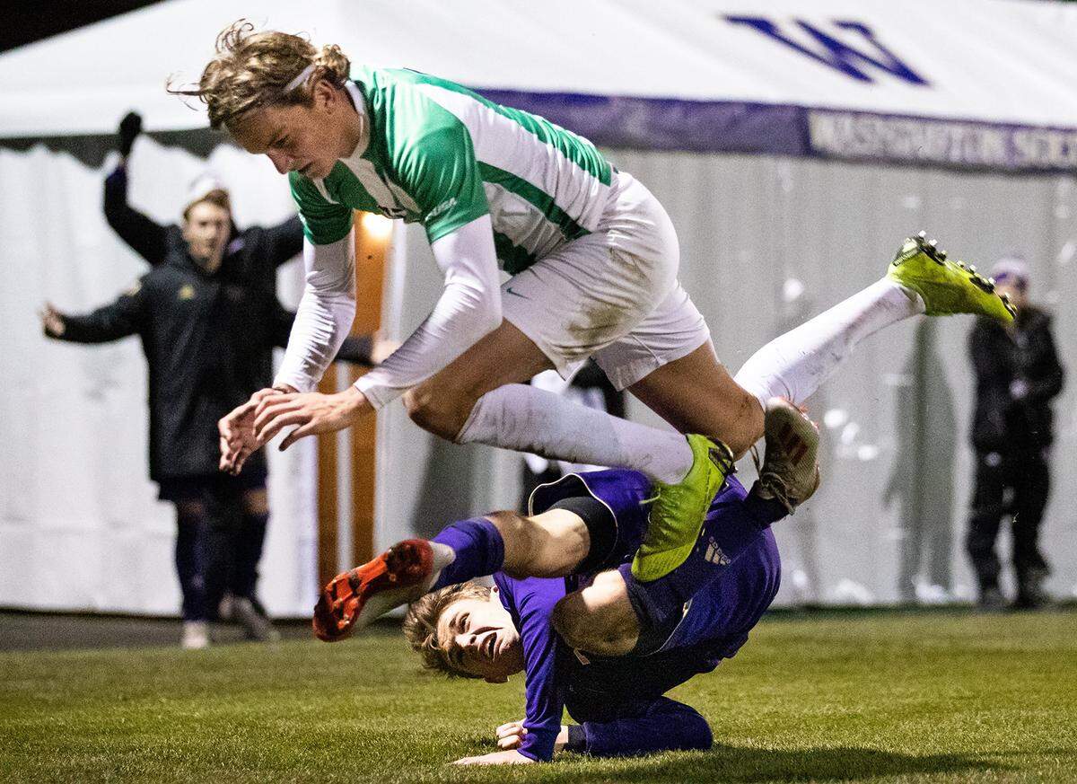 Washington’s Blake Bodily, bottom, and Marshall midfielder Max Schneider get tangled up during the Sweet 16 men’s soccer game Dec. 1 in Seattle.