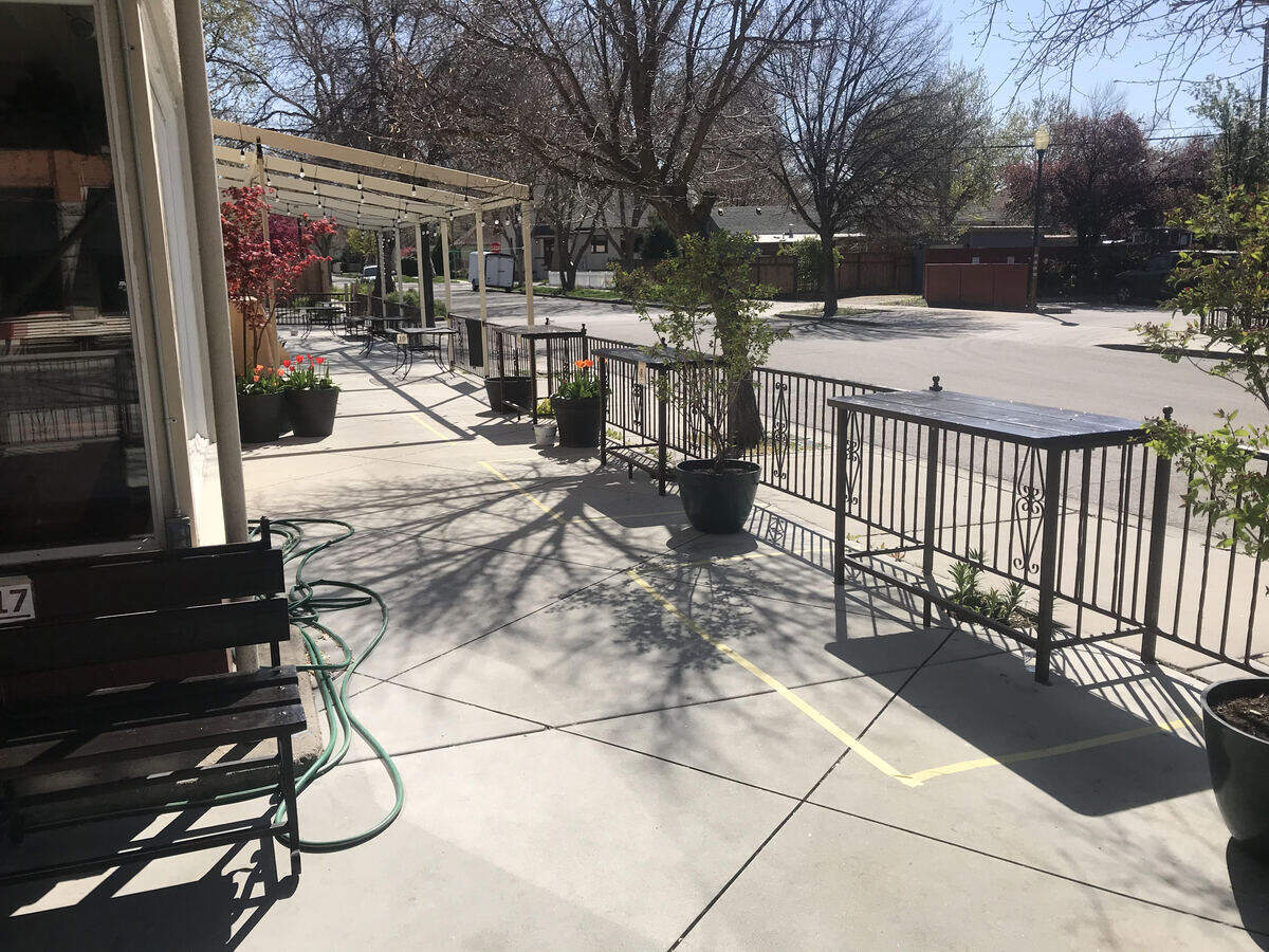 Patio tables are marked off with tape for social distancing at the Sun Ray Cafe.