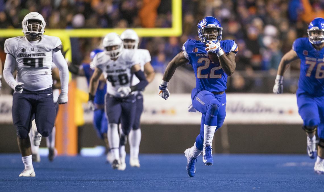 Boise State running back Alexander Mattison runs 59 yards to the 10-yard line late in the fourth quarter against Utah State. The run set up a touchdown that sealed the Broncos’ win.