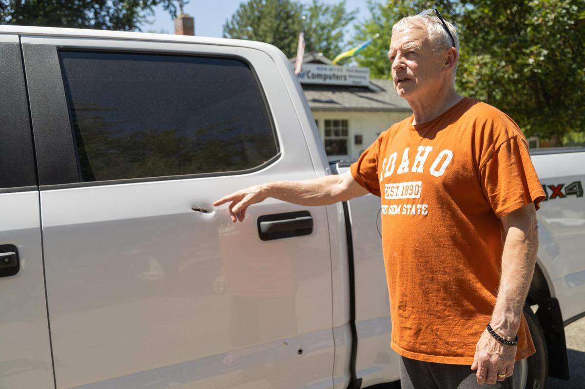 Keith Cox, 71, shows where his truck was struck by bullets during Wednesday night’s shootout in the North End that left a suspect dead. Cox, whose house also was hit, lives and was parked on Washington Street.