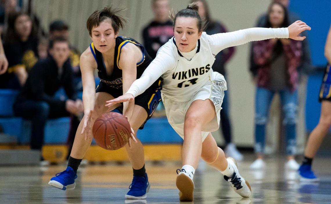 Caldwell’s Kaydence Moore, left, forces a turnover during last year’s 4A District Three championship game.