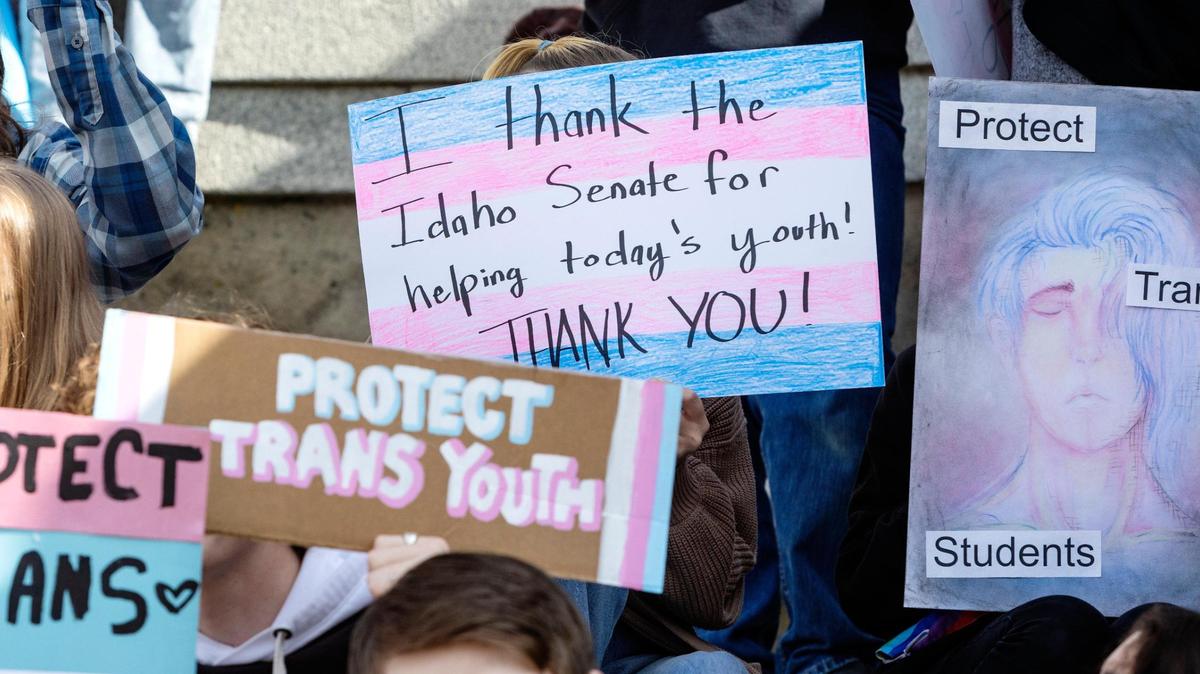 Transgender people, allies and family members of trans youth hold signs at the Idaho Capitol during a rally to celebrate the death of a bill that would have criminalized gender-affirming health care for children.