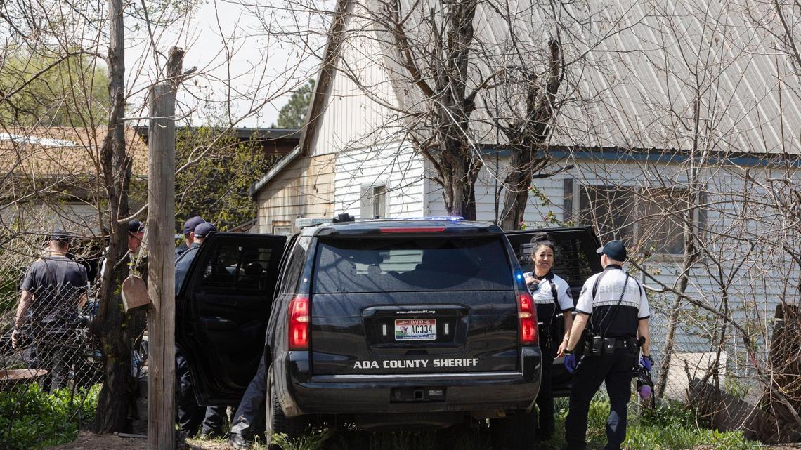 Officers from the Ada County Sheriff’s Office work alongside other law enforcement agencies at a residence on Cloverdale Road south of Overland Road on Thursday.