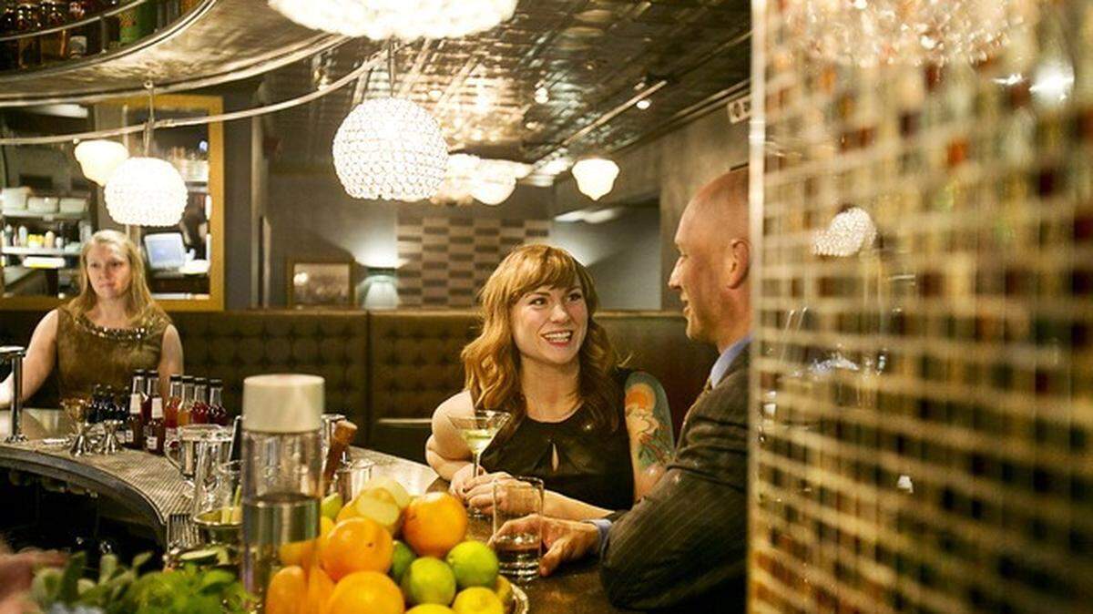 Kelly Barker talks to Russ Crawforth, owner of The Mode Lounge, during the new bar’s soft opening in Downtown Boise