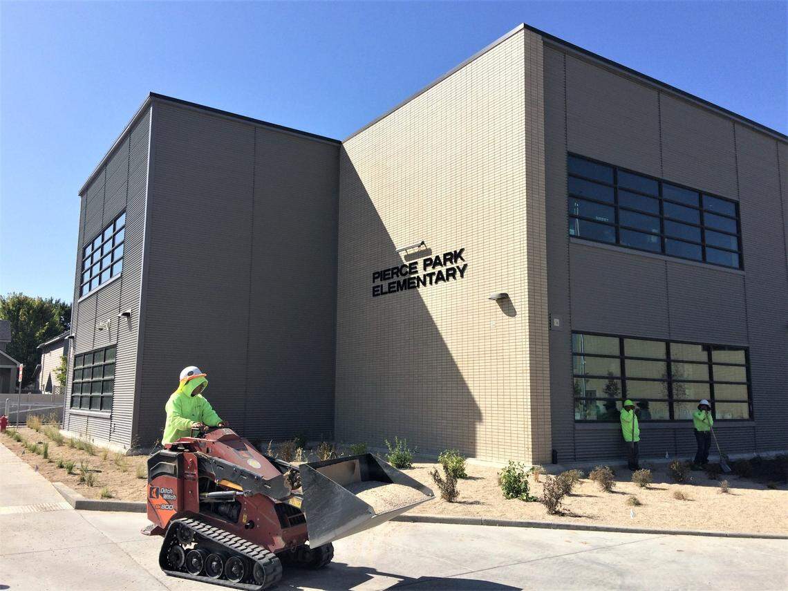 Landscape workers prepare the grounds of the Boise School District’s new Pierce Park Elementary School, 5015 N. Pierce Park Lane, on Thursday, Sept. 10.