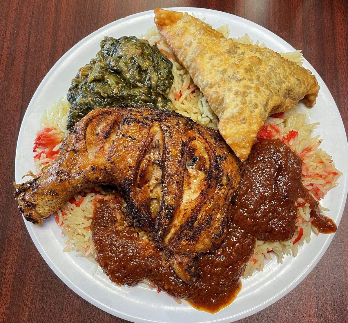 The grilled chicken at Amina’s is just how you want it — crispy on the outside, moist and flavorful under the skin, not greasy. The sambusas have great flavor and contrast.