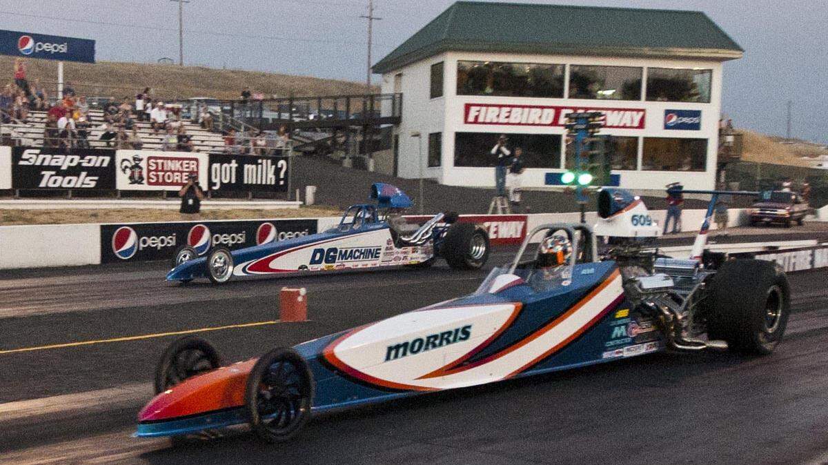 A racer crosses the finish line at the Nightfire Nationals at Firebird Raceway in 2012. The raceway just received a national historic designation.