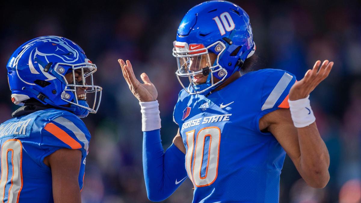 Boise State quarterback Taylen Green celebrates with teammate Eric McAlister after running 91 yards for a touchdown late in the Broncos’ the 42-23 win over Utah State on Friday.