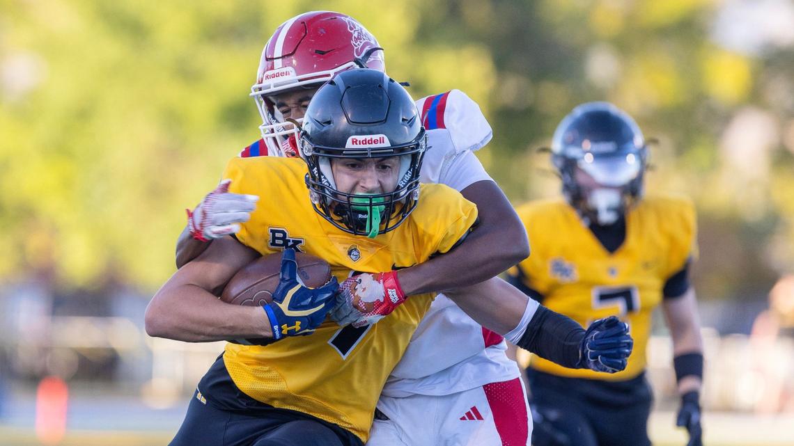 Bishop Kelly wide receiver Dom Wolthuis is stopped by Nampa defensive back junior Jayvon Portia in the first quarter of their game Friday in Boise.