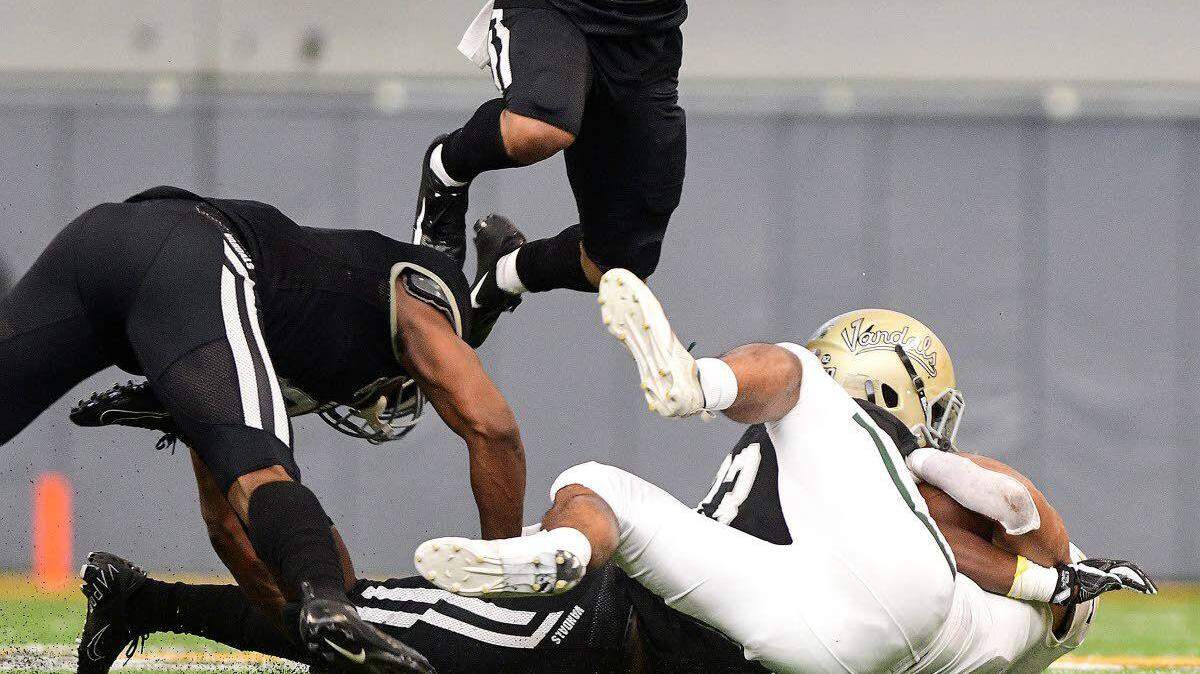 Idaho defensive lineman Leo Tamba (on ground) tackles Cal Poly fullback Duy Tran-Sampson during the fourth quarter of Saturday’s Big Sky game at the Kibbie Dome. In limited action this season, Tamba has registered 7½ tackles for loss, including 4½ in the previous two games.