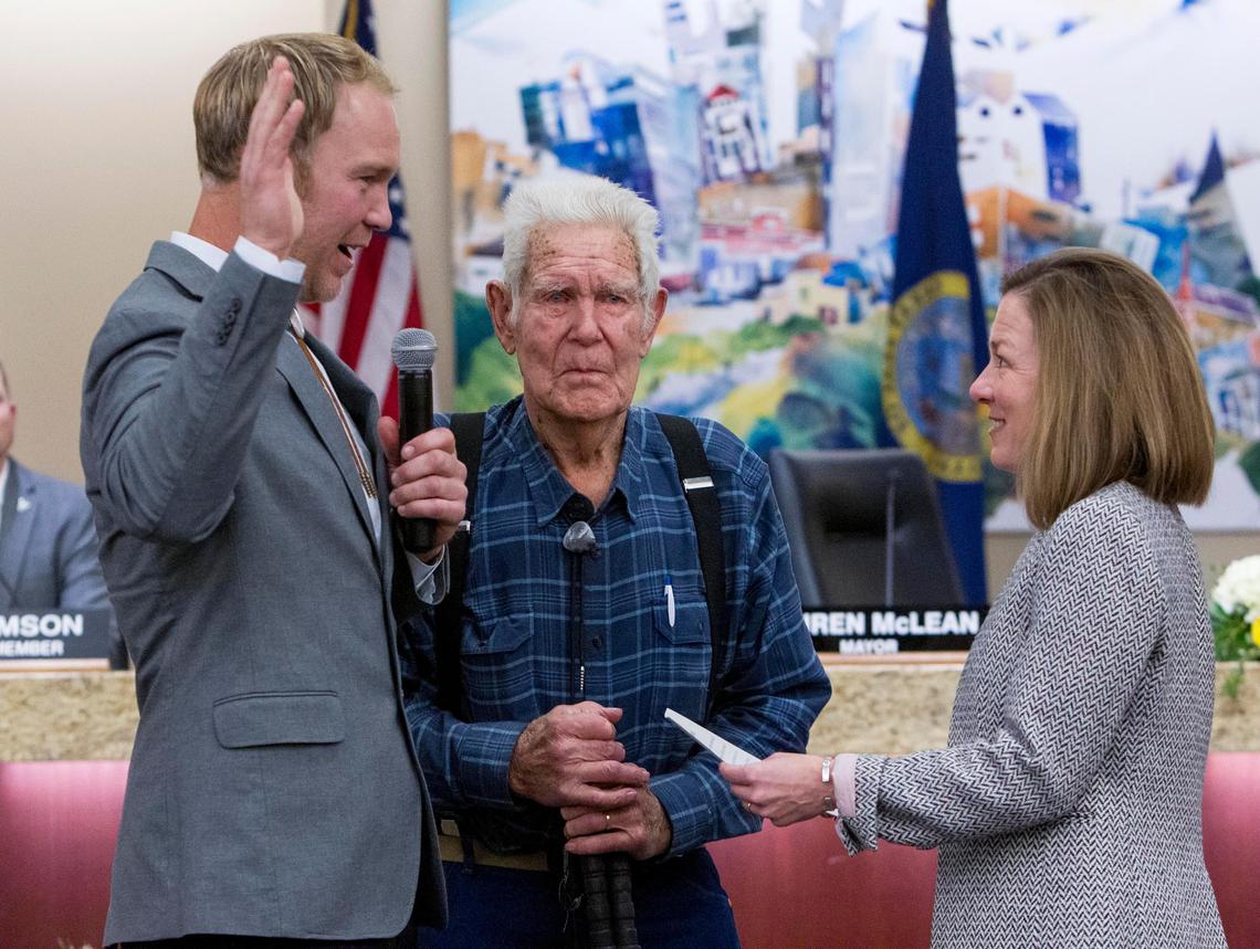 Jimmy Hallyburton, left, with grandfather Al Larson, center, was sworn in as a new member of the Boise City Council by Mayor Lauren McLean in 2020. He plans to run for reelection this fall.