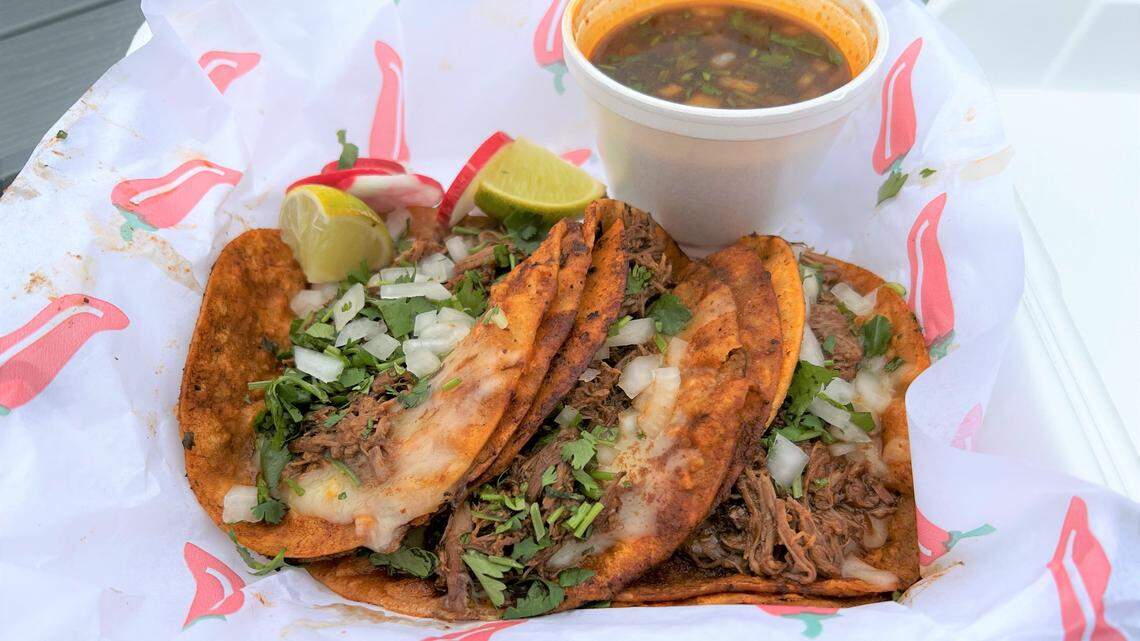 A quesabirria taco plate ($10) comes with three tacos, a side of consome for dipping, plus wedges of lime and radish. Two hot sauces are included on the side.