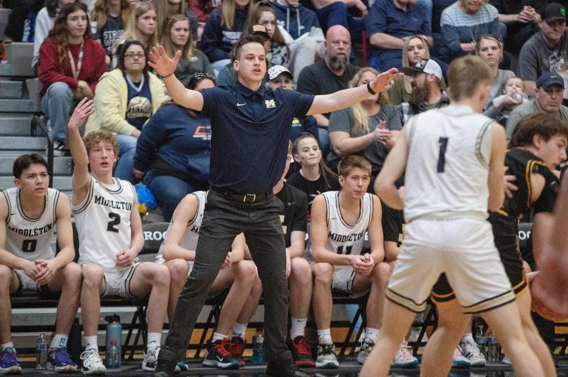 Middleton coach Nate Hartman gestures to his team during its game against Southern Idaho Conference rival Bishop Kelly in the first round of the 4A boys basketball state tournament.