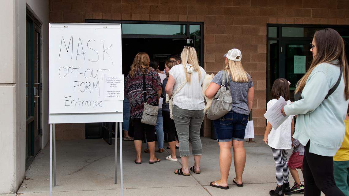 Parents in the West Ada School District lined up at the school administration building earlier this year to opt their children out of complying with a face mask mandate. The mandate became mandatory, but that’s going away.
