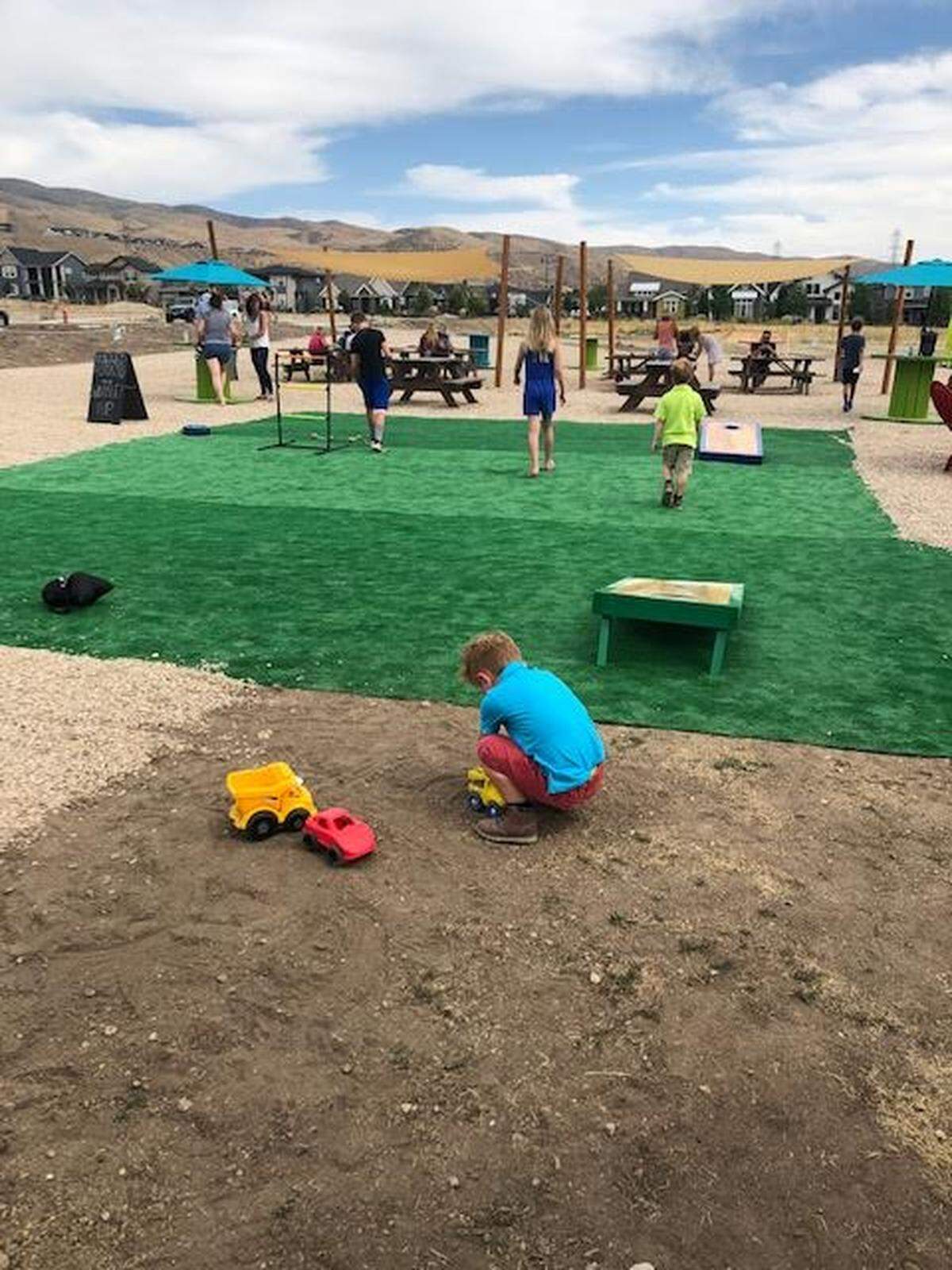 Families relax and play at Harris Ranch’s new food truck park.