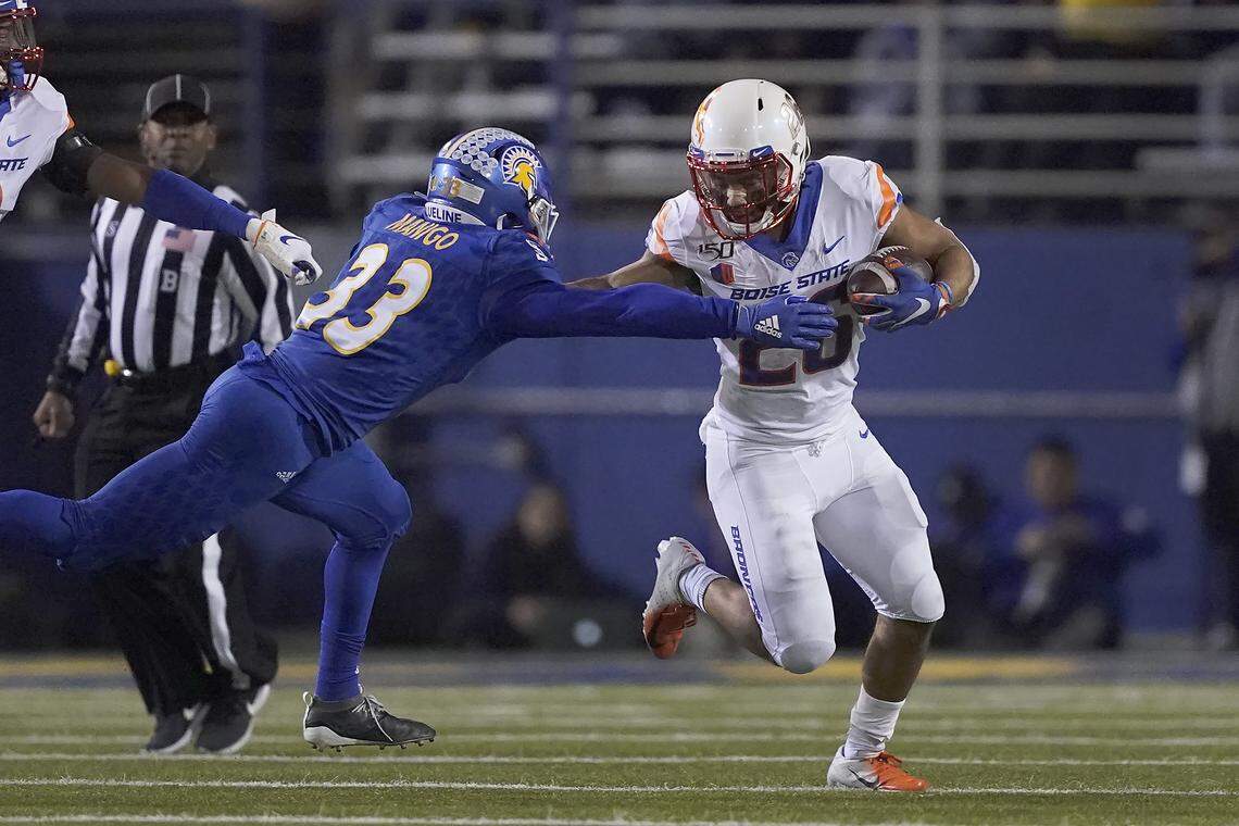 Boise State’s Avery Williams stiff arms San Jose State’s Brendan Manigo during his 66-yard punt return for a touchdown on Nov. 2 at San Jose State.