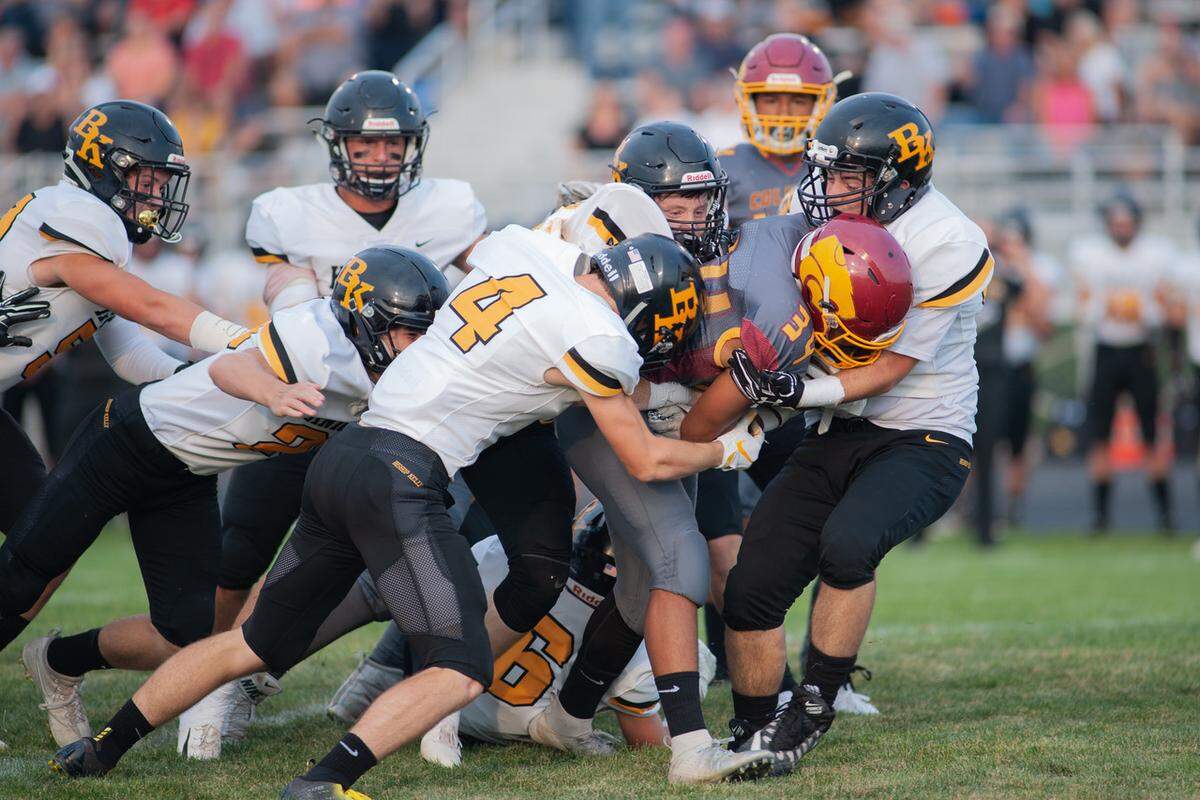 Columbia running back Allamar Alexander drags a pile of Bishop Kelly defenders forward during Week 1. Allamar is day-to-day with a knee contusion suffered last week against Vallivue.