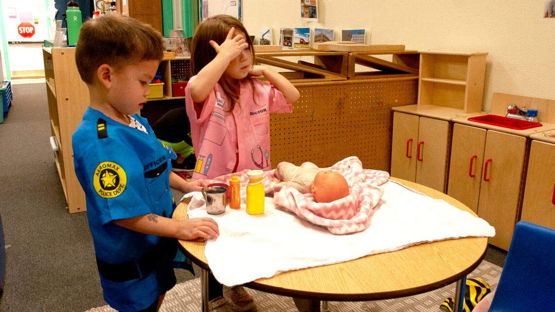 Jax Armstrong, 3, in police costume, plays with Naiya Aguilar, 4, at Giraffe Laugh Early Childhood Learning Center in Boise.
