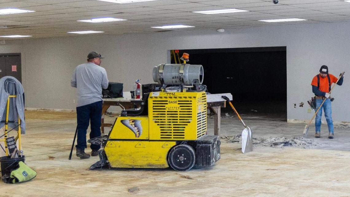 Workers remove carpet and floor tiles on Wednesday from the inside of the Interfaith Sanctuary building on State Street. Interfaith is remodeling the former Salvation Army warehouse. Eventually the building will include two floors of shelter beds.