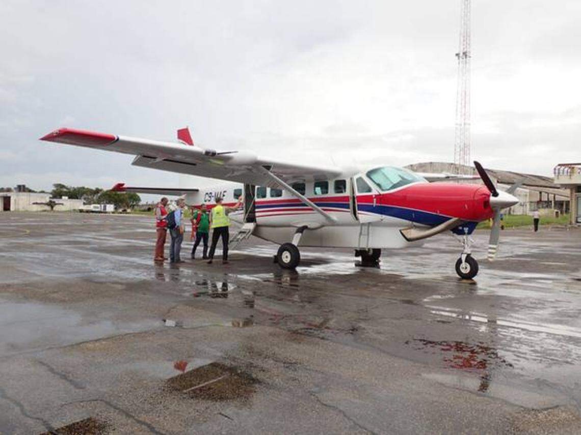 Pilots from Mission Aviation Fellowship prepare for a survey flight over the EN6 roadway, a major highway between Beira and Chimoio in Mozambique.