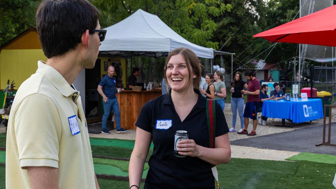 Camille Cressy talks with Brian Thrasher at a Boise Young Professionals social earlier this month at Boise Brew Putt.