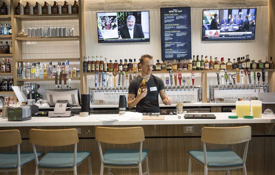 Broadway on the Rocks, upstairs at the Albertsons on Broadway Avenue, features a full bar and more than 30 beers on tap. Bartender Tavis Huff gets the bar ready before opening.