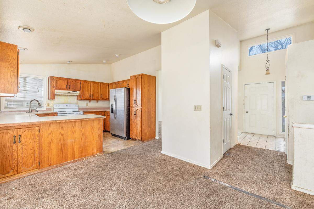 The kitchen and some parts of the carpet on the Poppy Street home are in need of repairs, as shown in this photo.