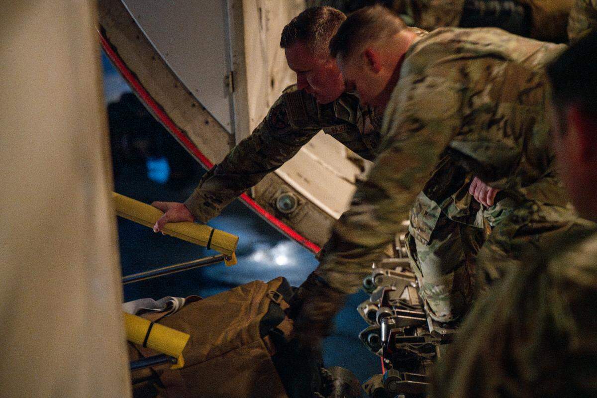 Airmen in the 124th Fighter Wing load bags on a contracted aircraft as they prepare for deployment.
