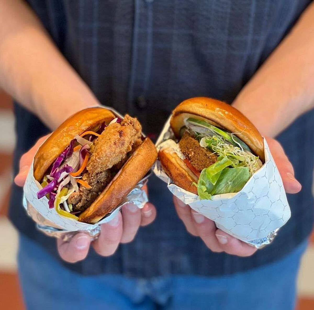 The Wyld Style Chicken Sandwich ($11.99), left, and Falafel Burger ($10.99) are two of the main entrees.