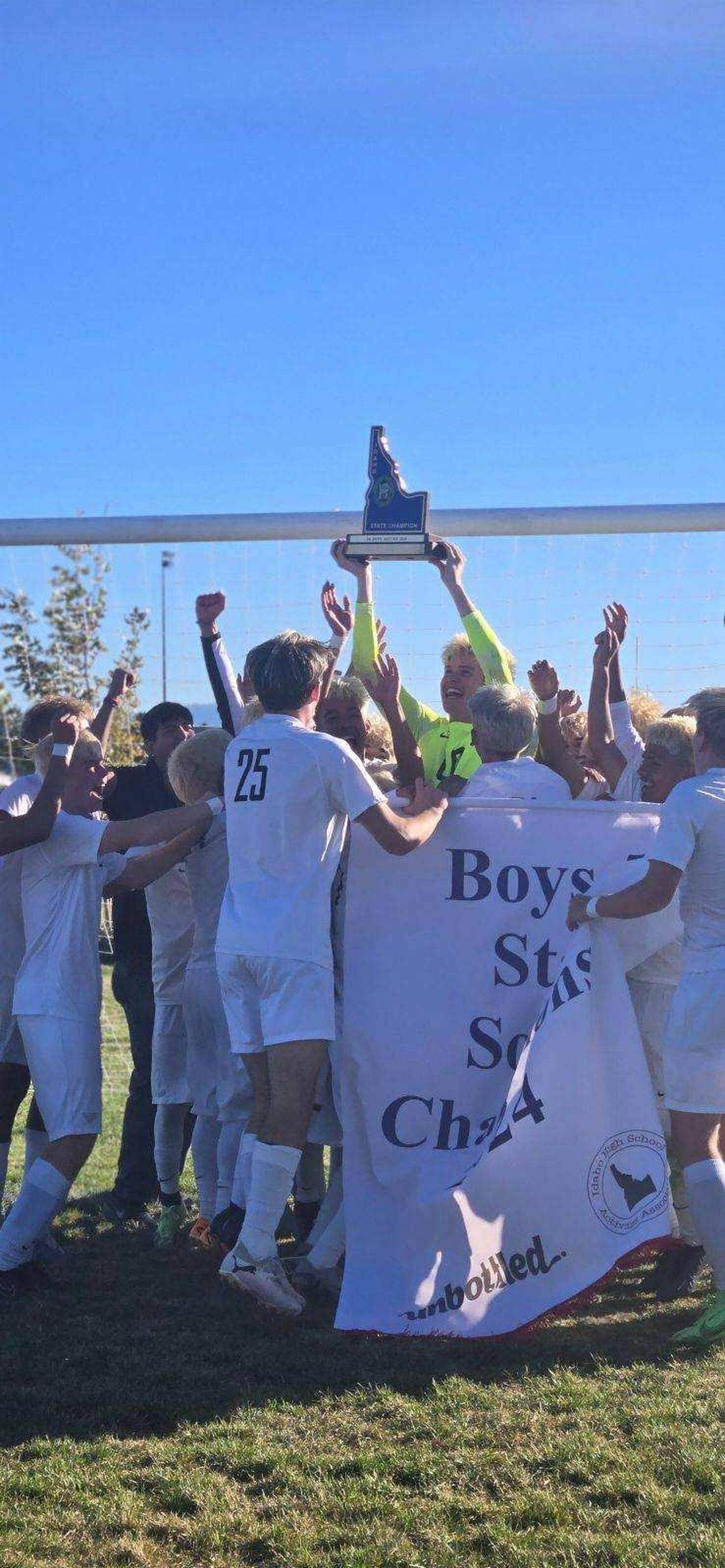 Vallivue goalkeeper Connor Blaisdell holds up the 5A championship trophy after the Falcons defeated Wood River 3-1 on Saturday at Bonneville High School in Idaho Falls.
