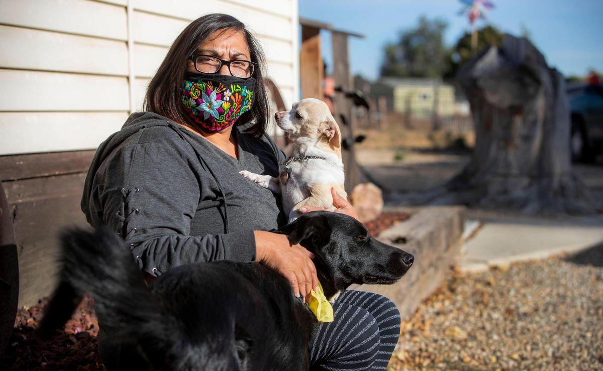 Raquel Reyes, with her dogs Chachi and Junior at her home in Caldwell, is one of the many Latinos in Idaho who contracted COVID-19. After testing positive with the coronavirus in early July after a family gathering, she is still struggling with complications.