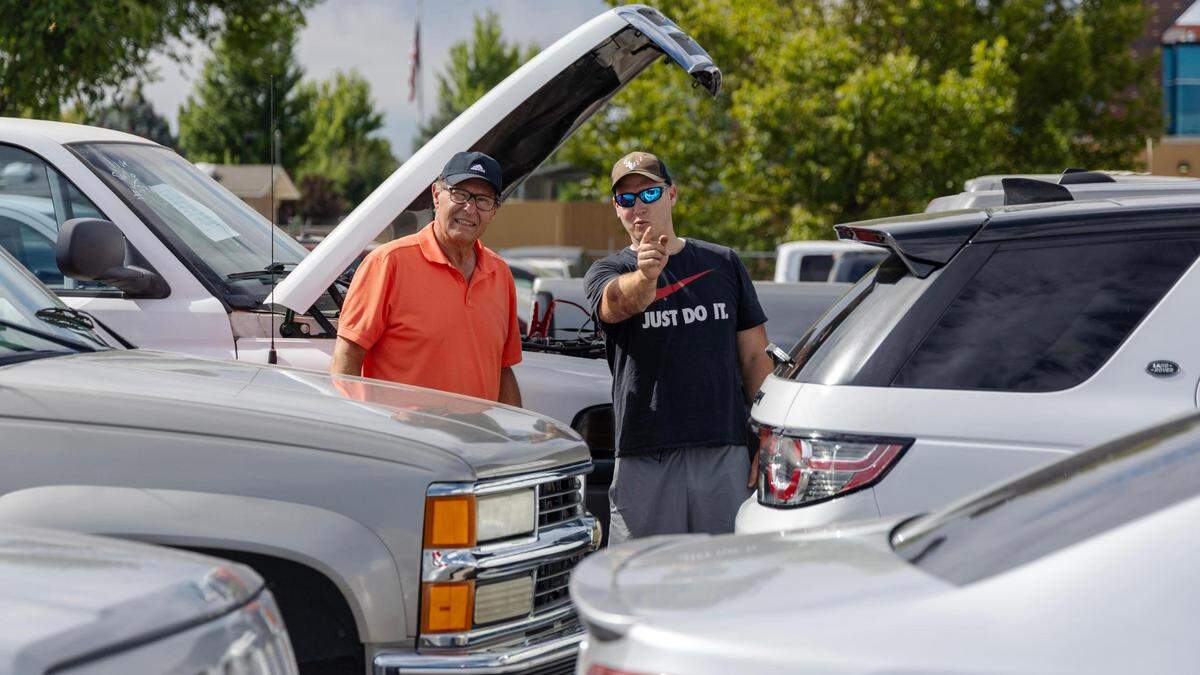 Ken Heninger, left, and son Mike check out vehicles at Musick Auction on Saturday.