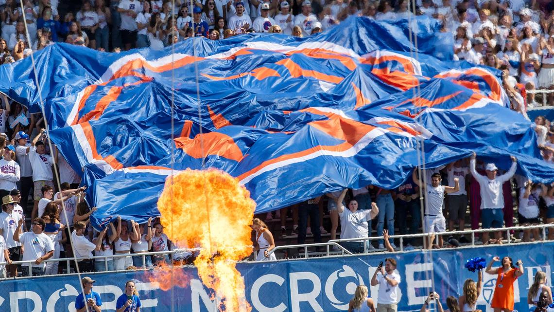Boise State students send up the Bronco banner as the football team enters Albertsons Stadium on Saturday.