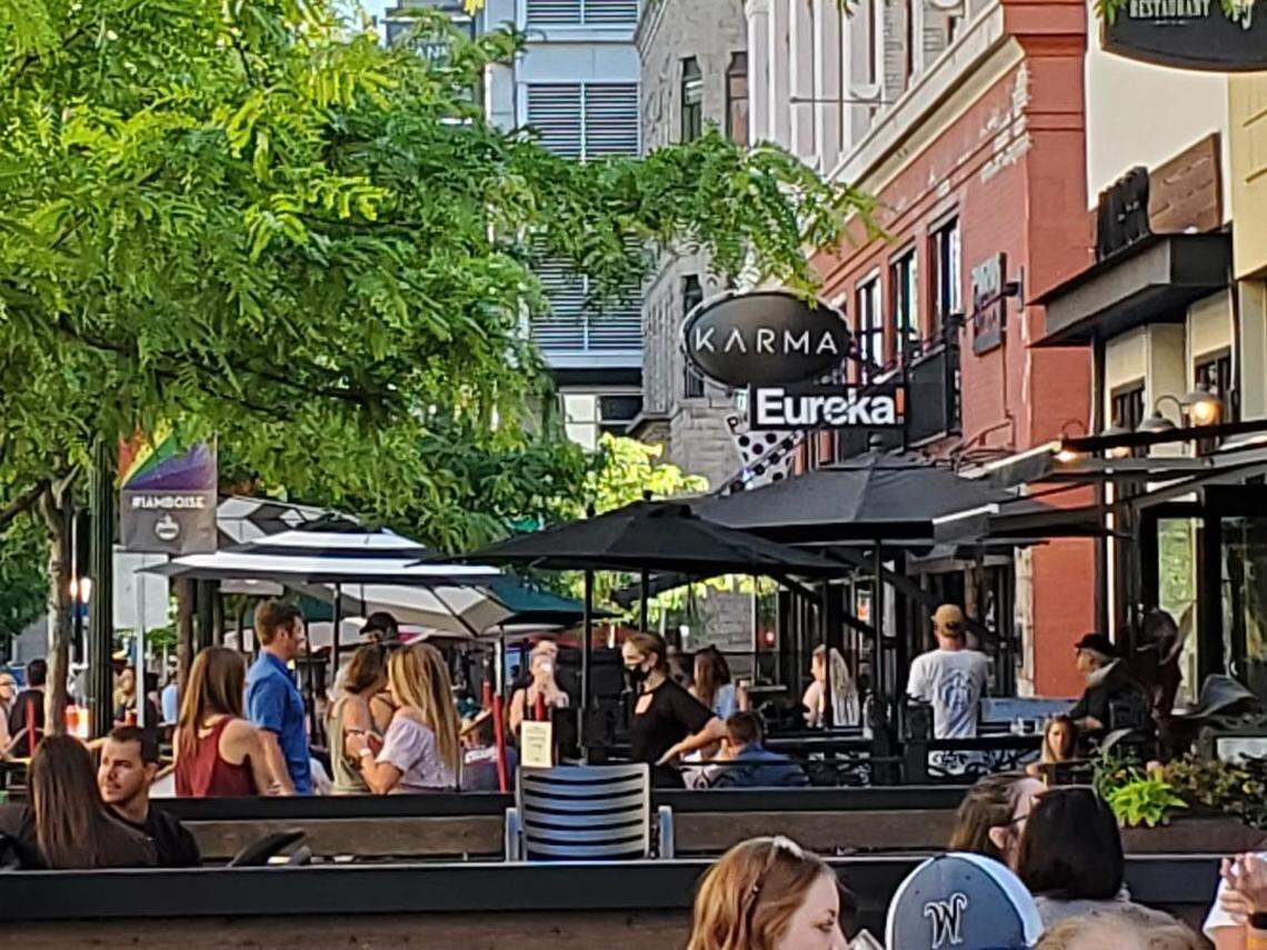 In this June file photo, people gather on newly expanded patios on 8th Street in front of Club Karma and the Eureka restaurant next door.