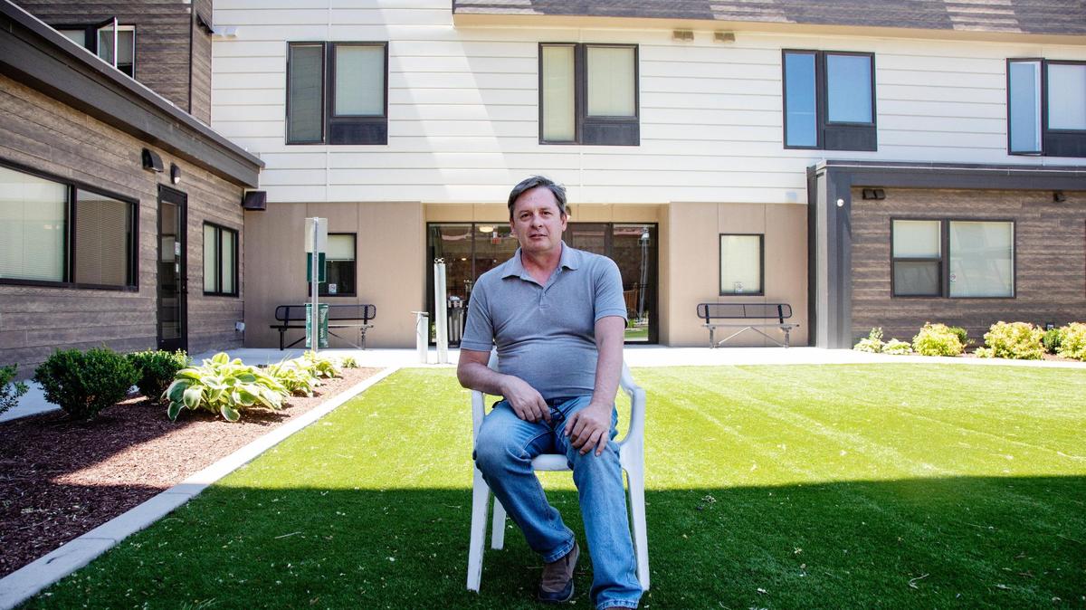 David Hall sits in the courtyard at New Path Community Housing. Hall has been a resident at New Path since 2019. Before that, he was homeless for seven years.