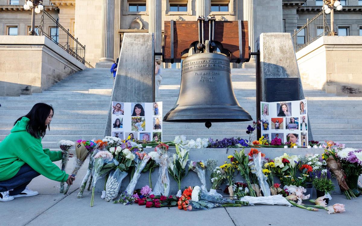 People leave flowers at a makeshift memorial during a vigil at the Idaho Capitol on Tuesday. March for Our Lives Idaho, a student-led organization against gun violence, held the vigil to remember the lives of the children and teachers killed in a school shooting in Uvalde, Texas one week ago.