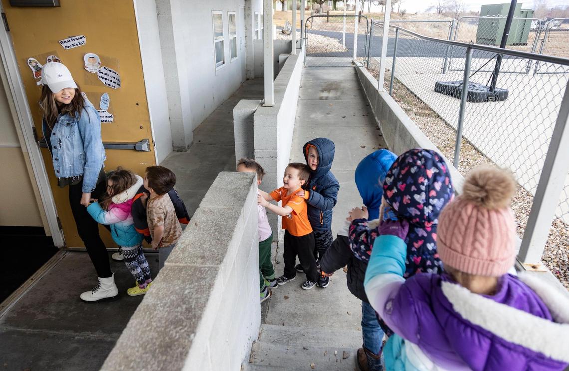 Children line up behind Johnson.