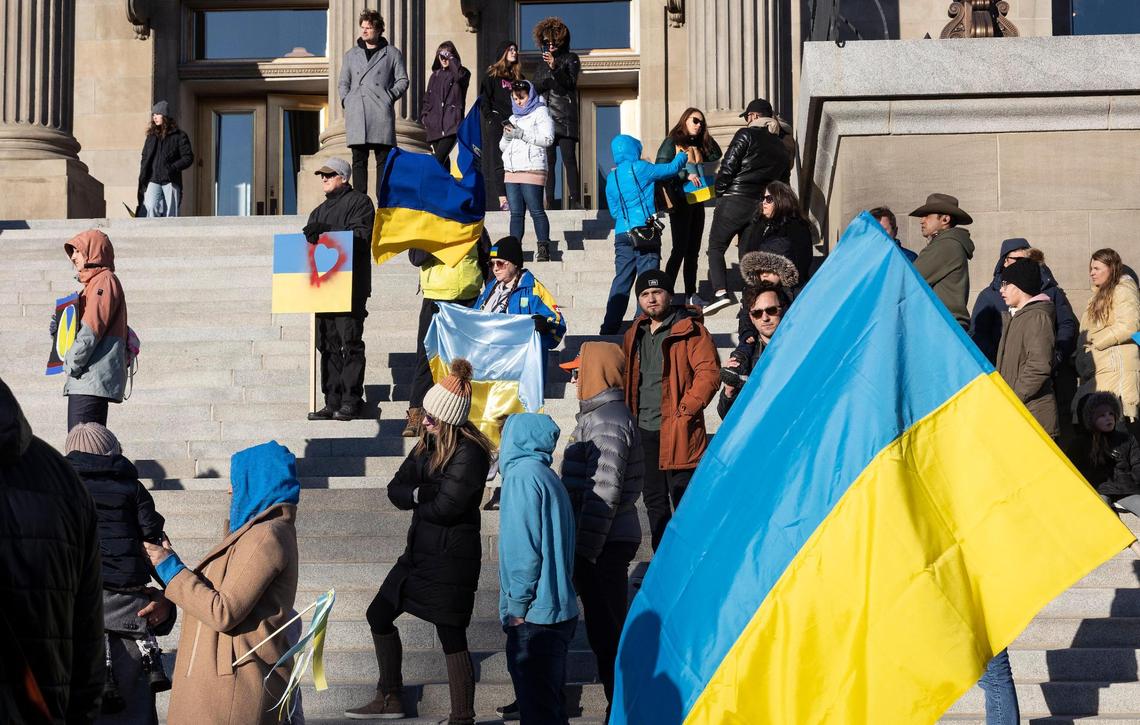 People gather with Ukraine flags outside of the Idaho Capitol Building on Saturday to rally against the Russian invasion of Ukraine.