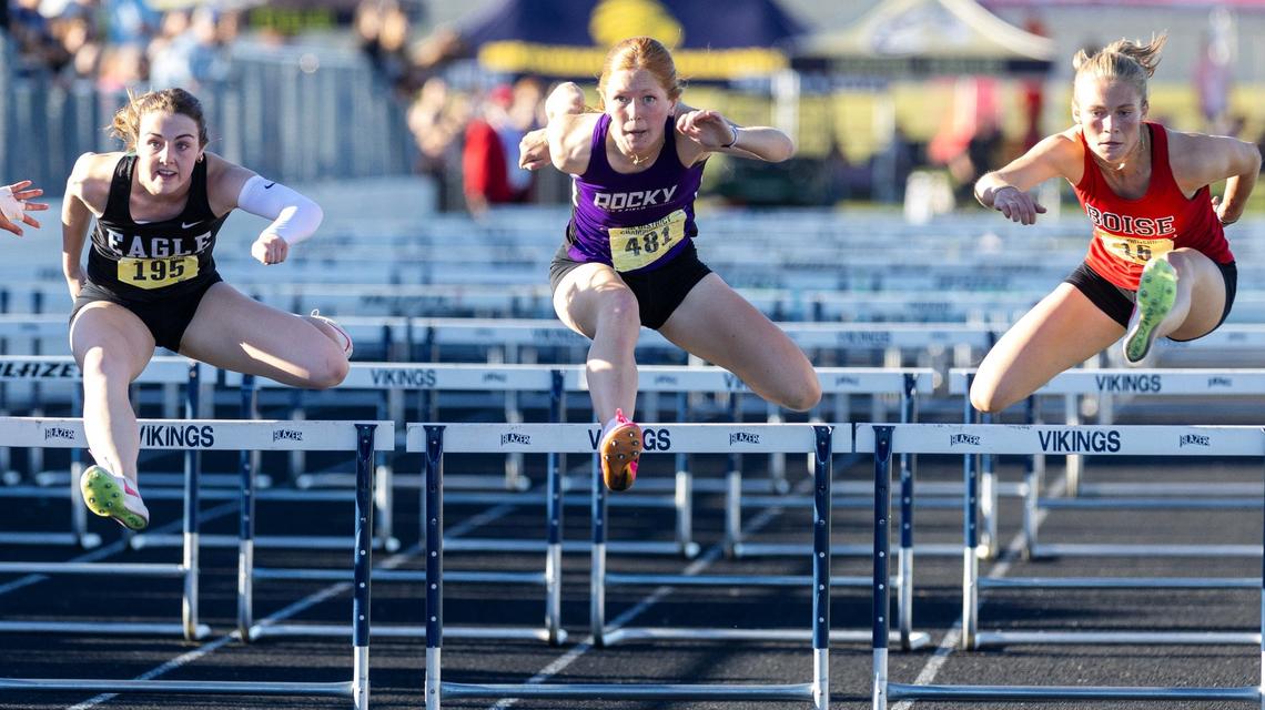 Eagle’s Makenzie Baisch, Rocky Mountain’s Hannah Pinegar and Boise’s Grace Lanfear compete in the girls 100-meter hurdles at the 5A District Three Track and Field Championships held Friday at Middleton High School.