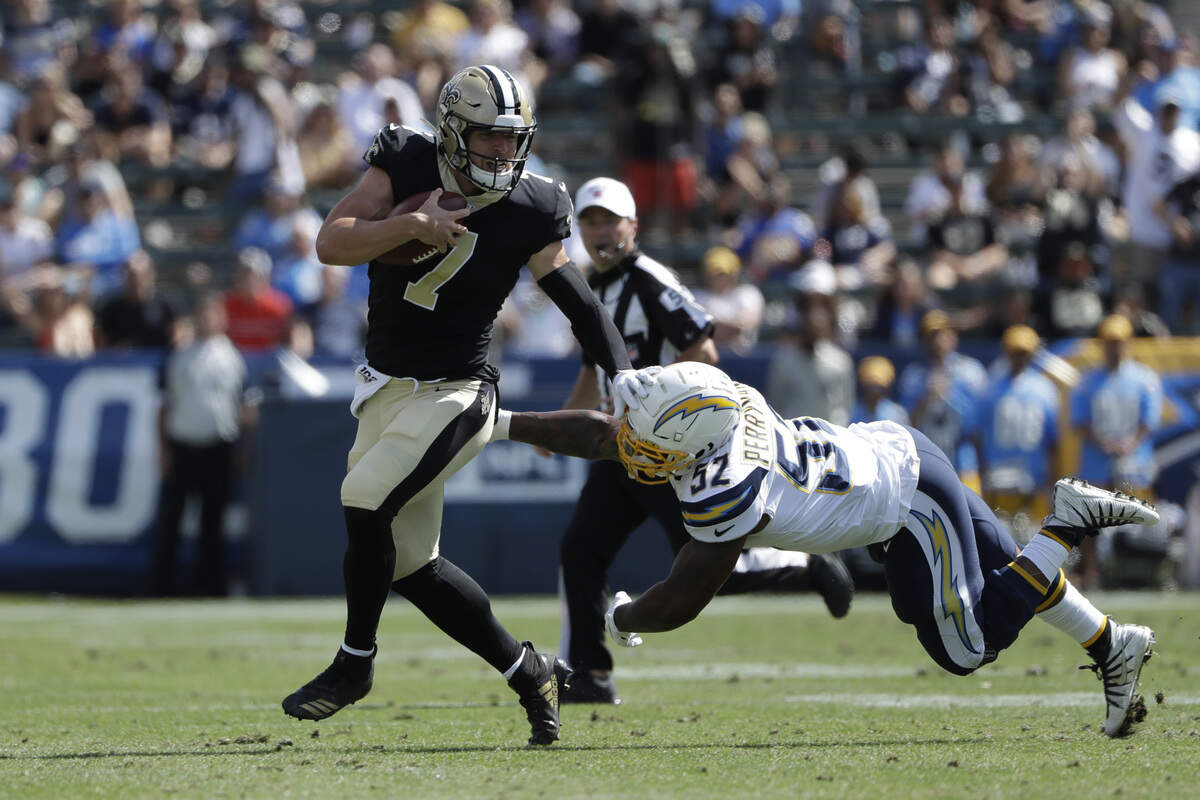 New Orleans quarterback Taysom Hill stiff arms a defender to the ground during a preseason game against the Los Angeles Chargers last month. The Saints have former Vikings quarterback Teddy Bridgewater ready to start Sunday against the Seahawks at CenturyKink Field, but Hill could also have a package of plays at QB beyond the running and receiving he’s done the last three seasons for New Orleans.